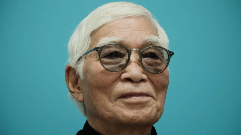 Film still from Masao Adachi Takes a Passport Photo